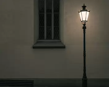 Silent Geometry A lone street lamp glows softly beside an old window and an empty bench, casting subdued light across a quiet, dimly toned city wall.