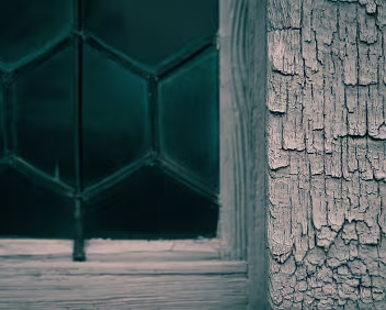 Weathered Pane Cracked paint and softened edges frame a window that filters more than light. Exposure and neglect leave a quiet, layered texture behind.
